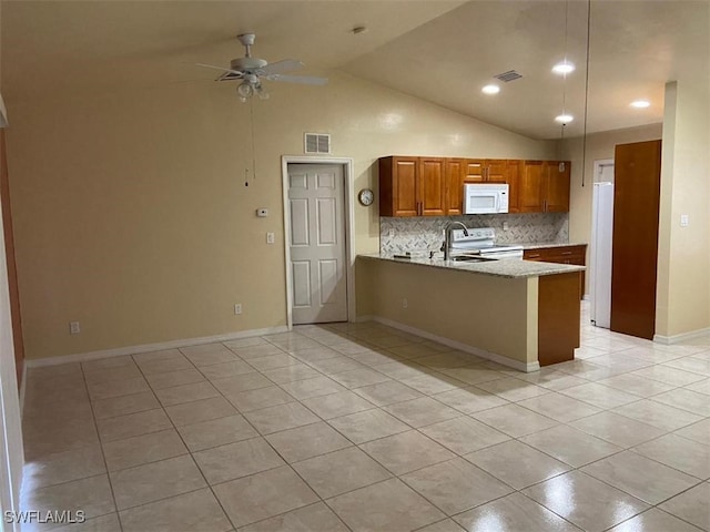 kitchen with kitchen peninsula, ceiling fan, light tile patterned floors, and white appliances