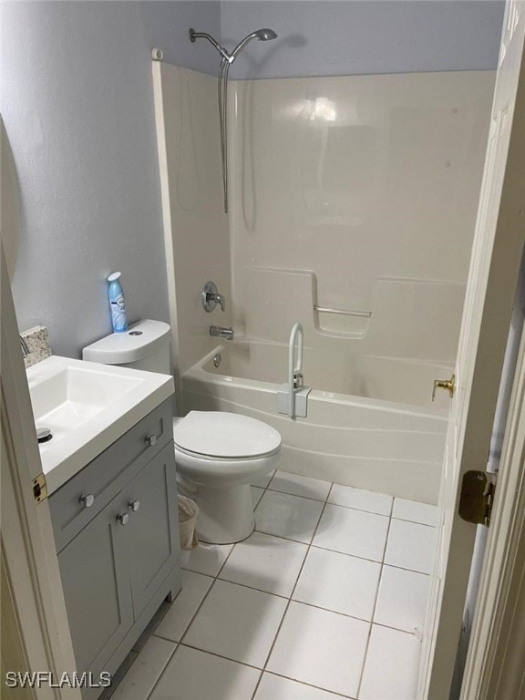 full bathroom featuring toilet, vanity, bathing tub / shower combination, and tile patterned floors