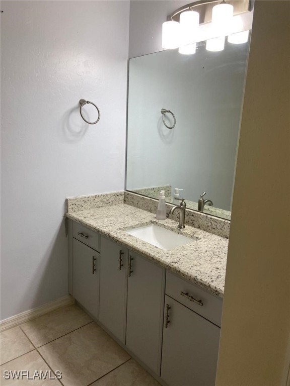 bathroom featuring tile patterned flooring and vanity