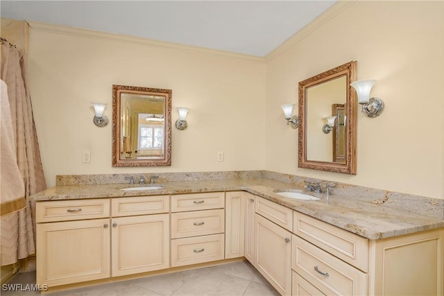 bathroom featuring tile patterned flooring, vanity, and crown molding