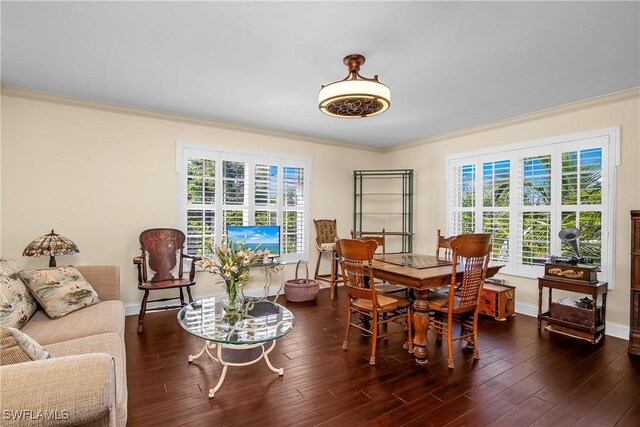 dining room with plenty of natural light, dark hardwood / wood-style floors, and ornamental molding