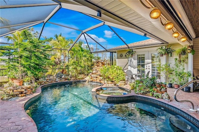 view of swimming pool with a lanai, a patio area, an in ground hot tub, and french doors