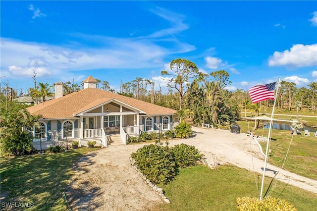 single story home with a porch and a front yard