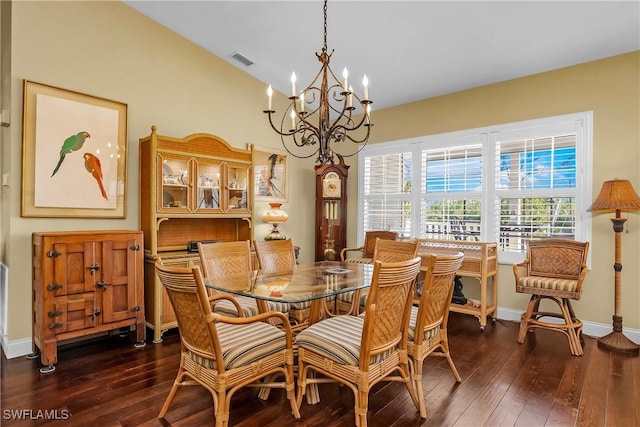 dining room with dark hardwood / wood-style floors and a chandelier