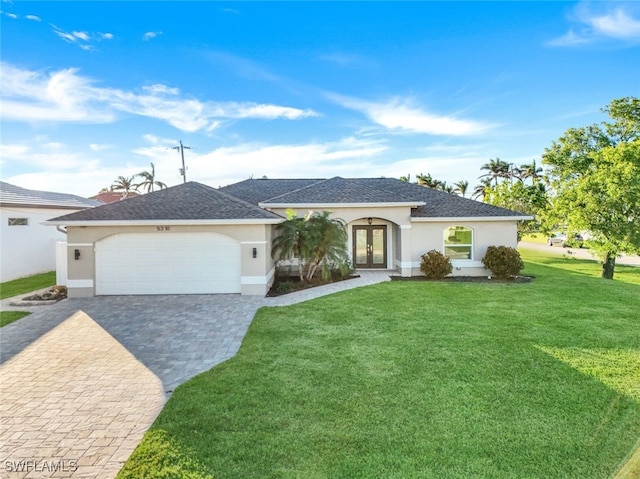 ranch-style home featuring french doors, a front lawn, and a garage