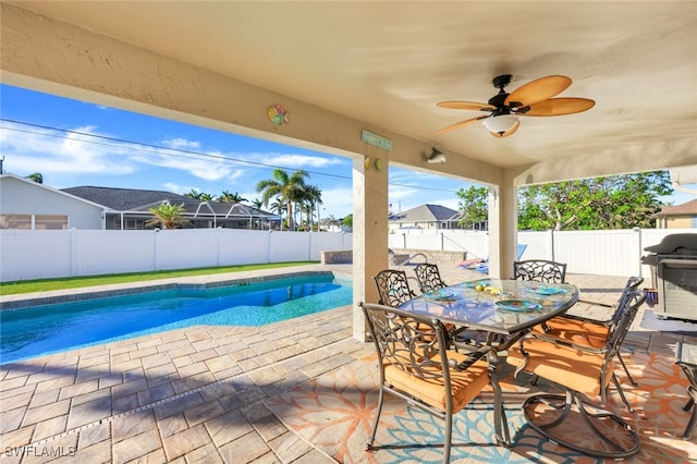 view of swimming pool featuring ceiling fan, a grill, and a patio area