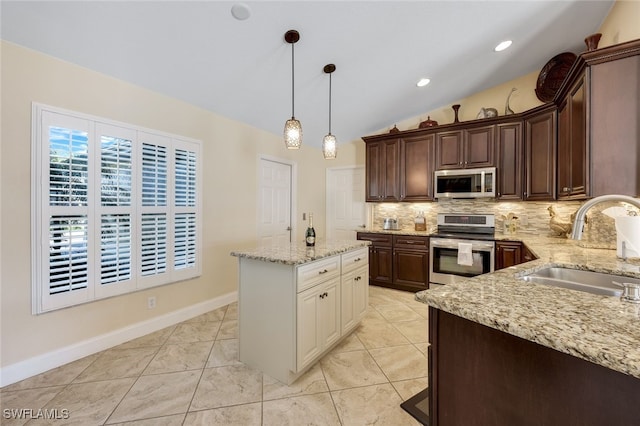 kitchen featuring sink, vaulted ceiling, tasteful backsplash, dark brown cabinetry, and stainless steel appliances