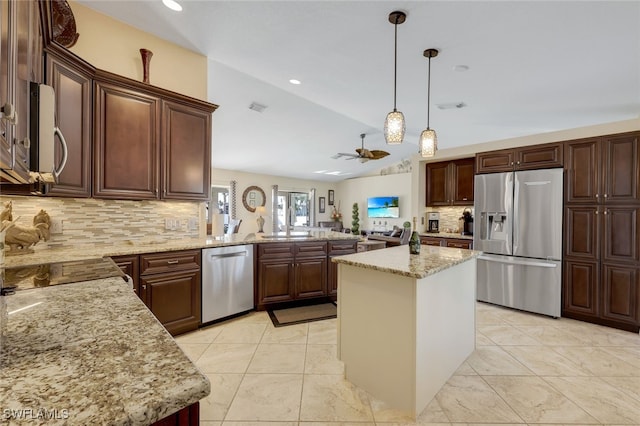 kitchen with kitchen peninsula, stainless steel appliances, ceiling fan, decorative light fixtures, and a center island