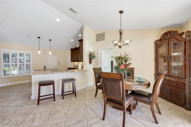 dining space featuring sink and a chandelier