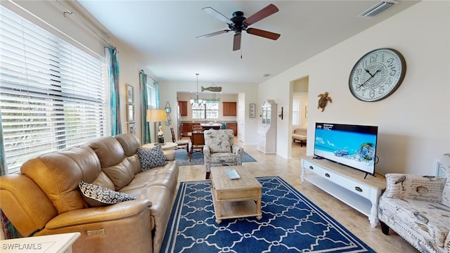 tiled living room with ceiling fan