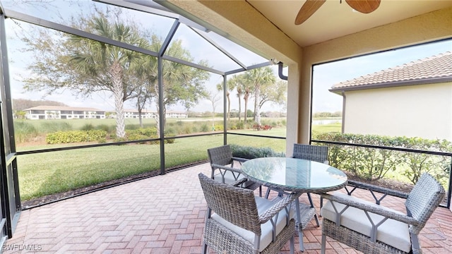 sunroom featuring ceiling fan