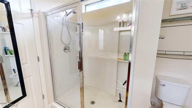 bathroom featuring toilet and walk in shower