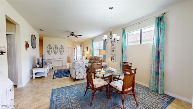 dining area with ceiling fan with notable chandelier