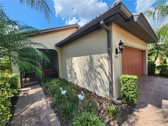 view of side of home featuring a garage