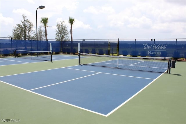 view of tennis court featuring basketball court