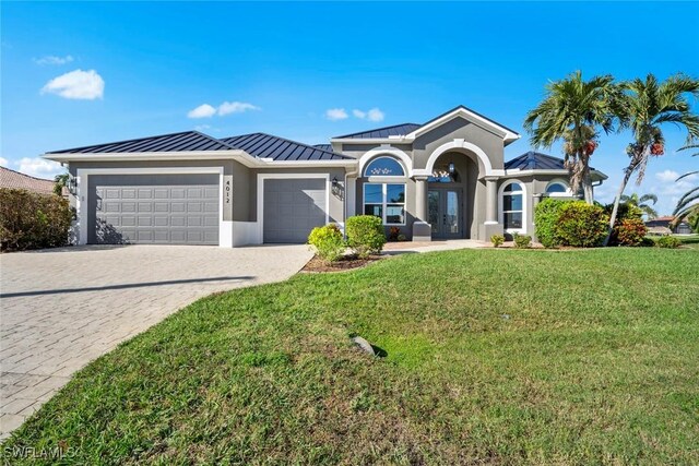 view of front of property with a garage and a front lawn