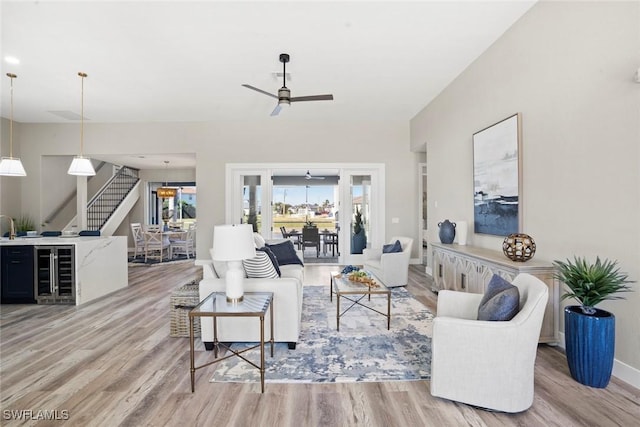 living room with wine cooler, ceiling fan, and wood-type flooring