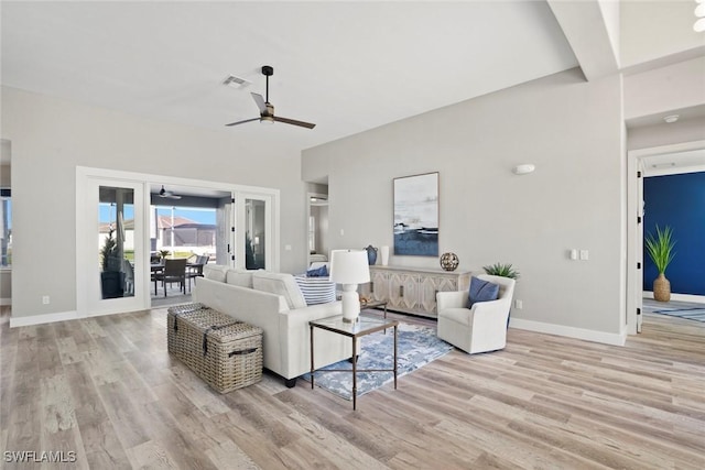 living room featuring light hardwood / wood-style flooring and ceiling fan