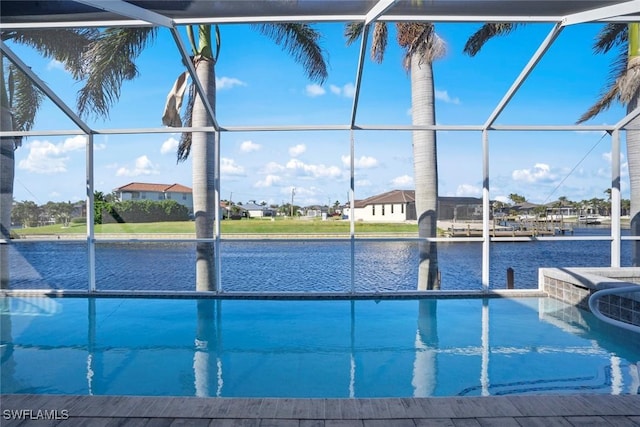 view of pool with a lanai and a water view