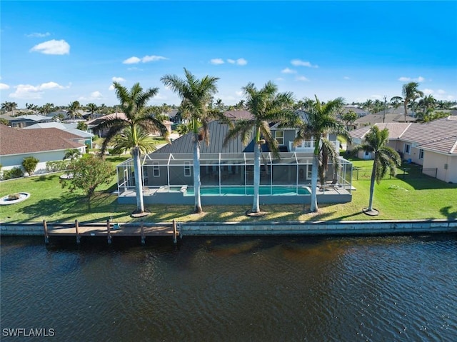 dock with a residential view, a water view, a lawn, and a lanai