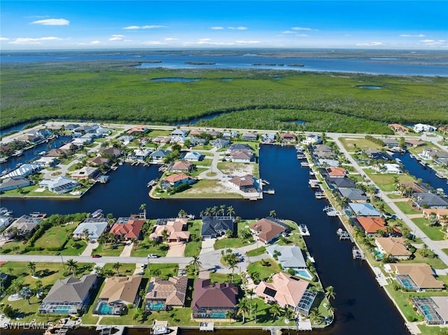 view of property location featuring a large body of water and nearby suburban area