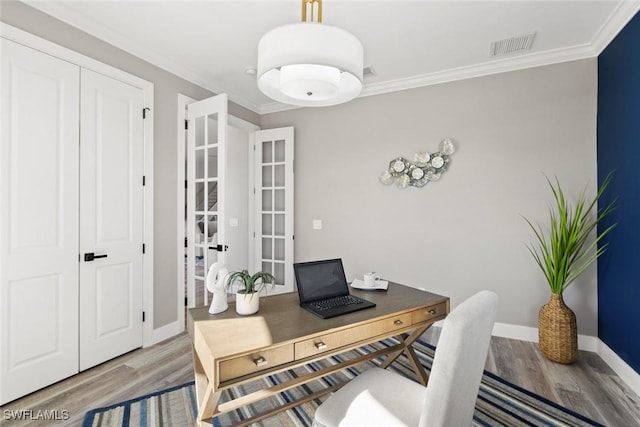 home office with crown molding, hardwood / wood-style floors, and french doors