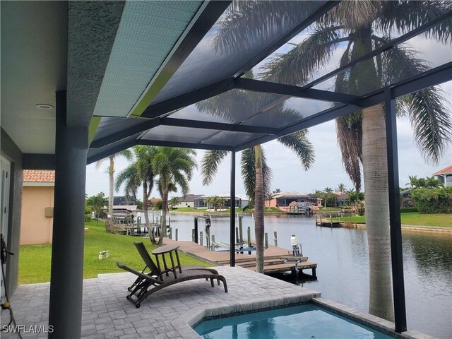 outdoor pool featuring a water view, a boat dock, a patio, a yard, and a lanai