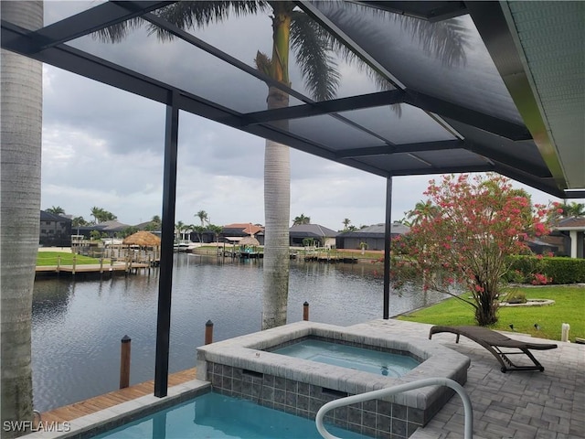 view of swimming pool featuring a water view, an in-ground hot tub, and a residential view