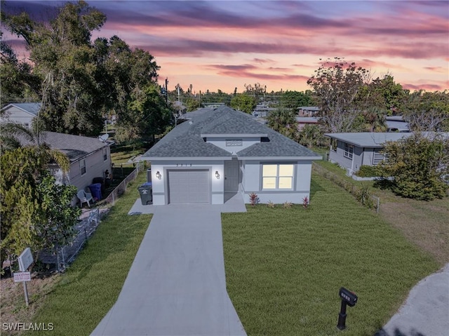 view of front of property featuring a lawn and a garage