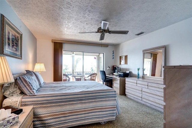 carpeted bedroom with access to outside, ceiling fan, and a textured ceiling