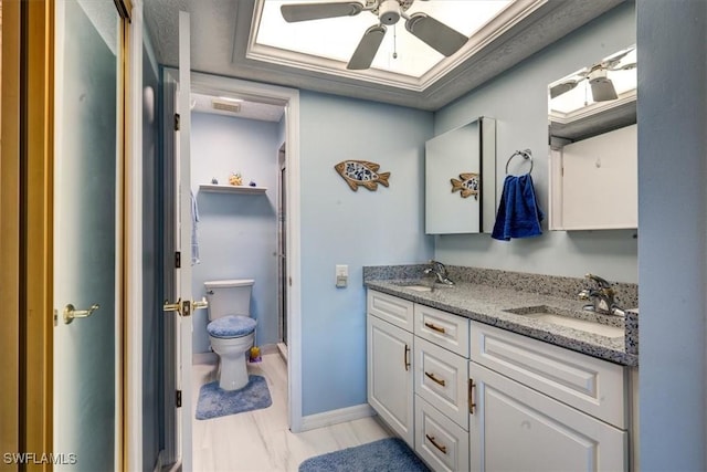 bathroom with vanity, toilet, and ceiling fan