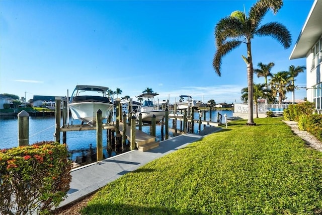 view of dock featuring a water view and a lawn