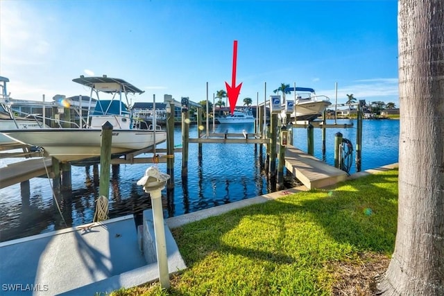 view of dock with a yard and a water view