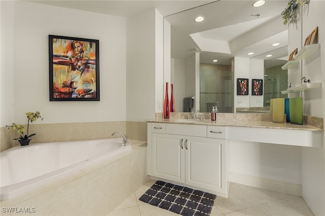 bathroom featuring tile patterned flooring, vanity, and shower with separate bathtub