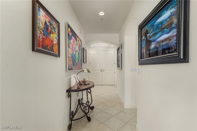 hall featuring light tile patterned floors