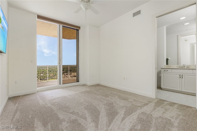 carpeted empty room with ceiling fan and sink