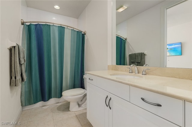 bathroom featuring tile patterned flooring, vanity, and toilet