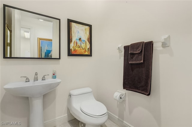 bathroom with tile patterned floors, sink, and toilet