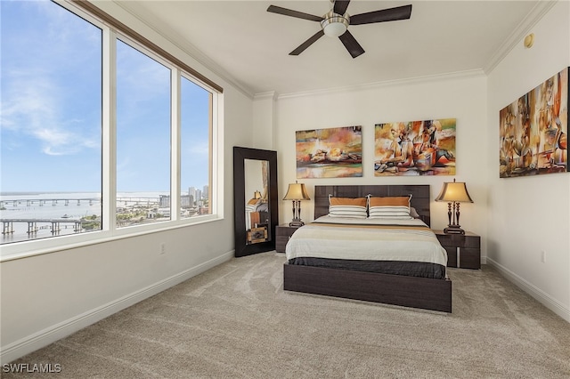 bedroom featuring carpet, ceiling fan, a water view, and ornamental molding