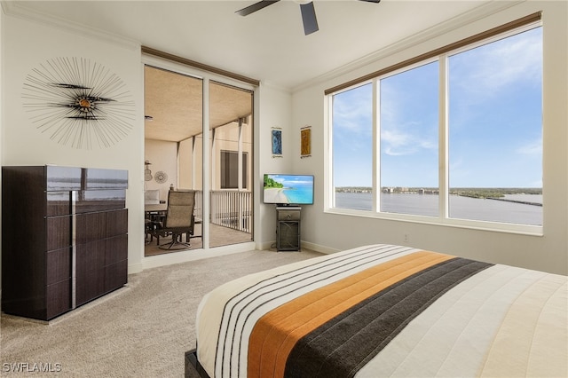 carpeted bedroom featuring ceiling fan and ornamental molding