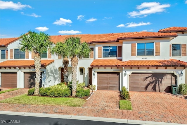 9462 Montebello Way Unit 107, Fort Myers, FL 33908 - multi unit property with stucco siding, a tile roof, decorative driveway, and a garage
