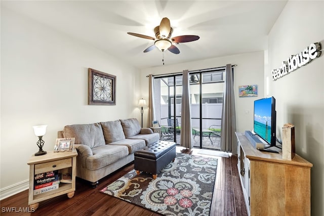 living room with ceiling fan and dark hardwood / wood-style floors