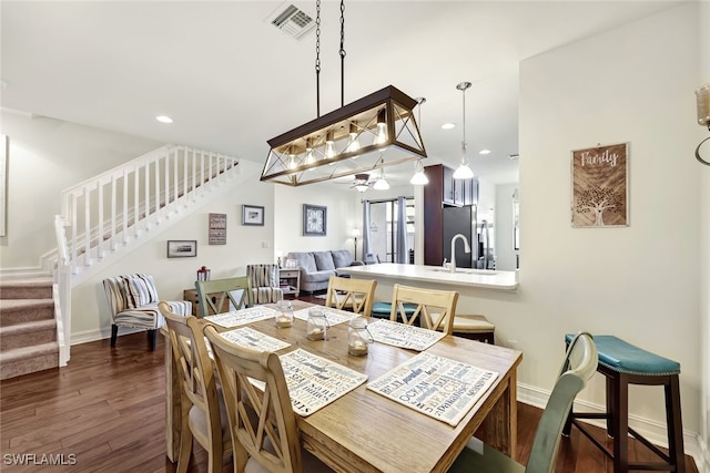 dining room featuring sink and dark hardwood / wood-style floors