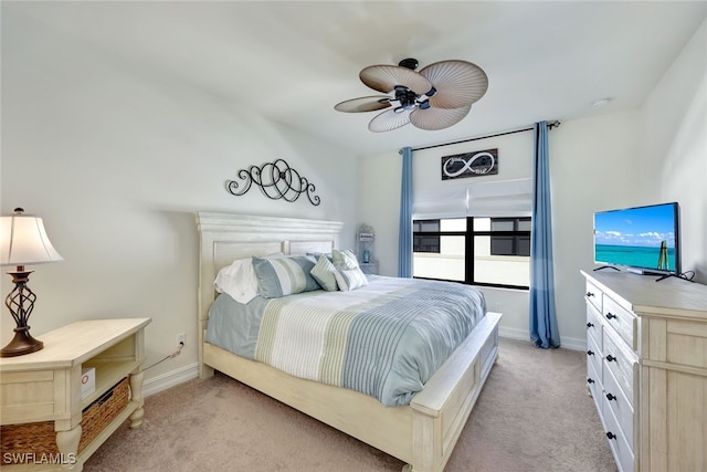 bedroom featuring light colored carpet and ceiling fan