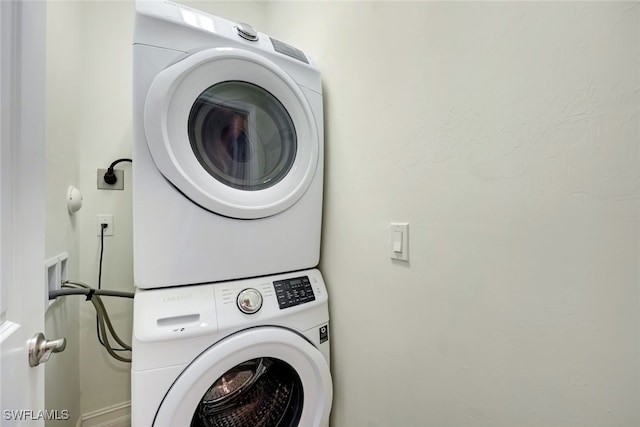 laundry room with stacked washer / dryer