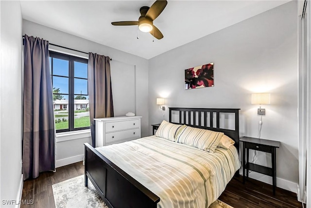 bedroom with ceiling fan and dark hardwood / wood-style flooring