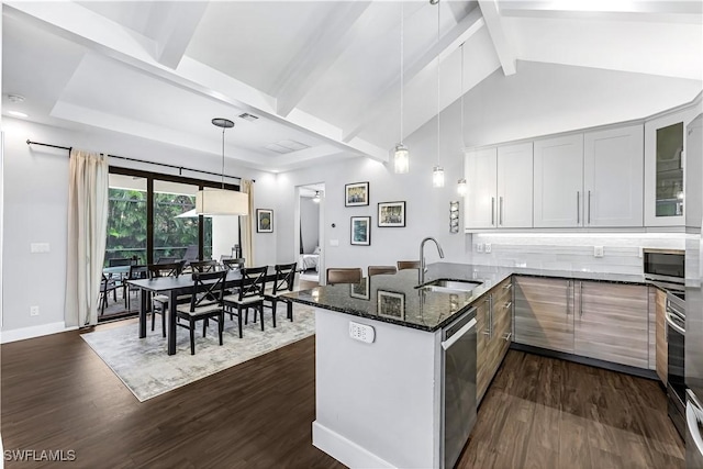 kitchen with pendant lighting, white cabinets, sink, kitchen peninsula, and stainless steel appliances