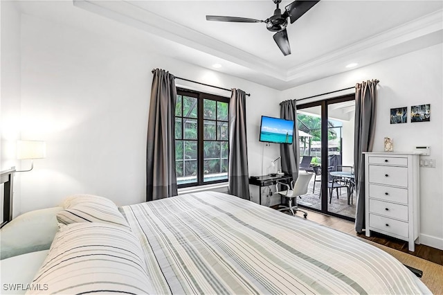 bedroom featuring access to outside, multiple windows, ceiling fan, and wood-type flooring