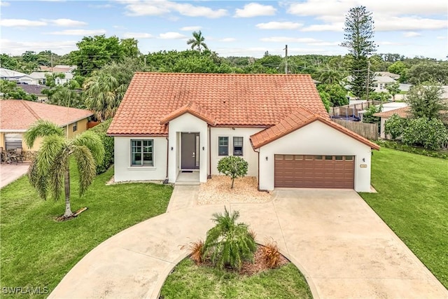 mediterranean / spanish house with a garage and a front yard