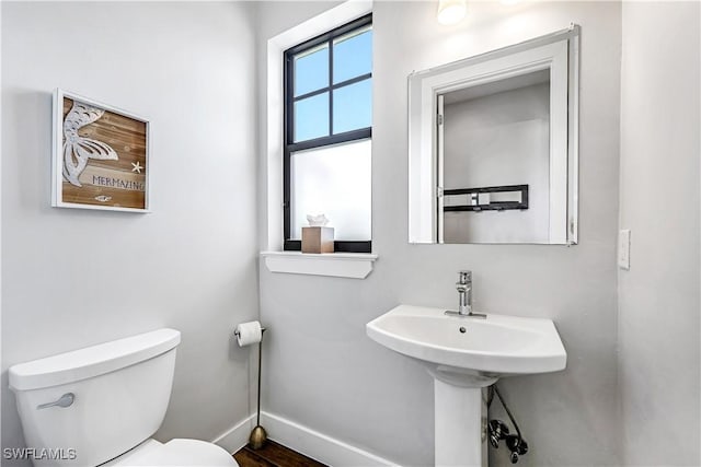 1140 Jeronimo Dr, Naples, FL 34103 - half bathroom with toilet, baseboards, and wood finished floors